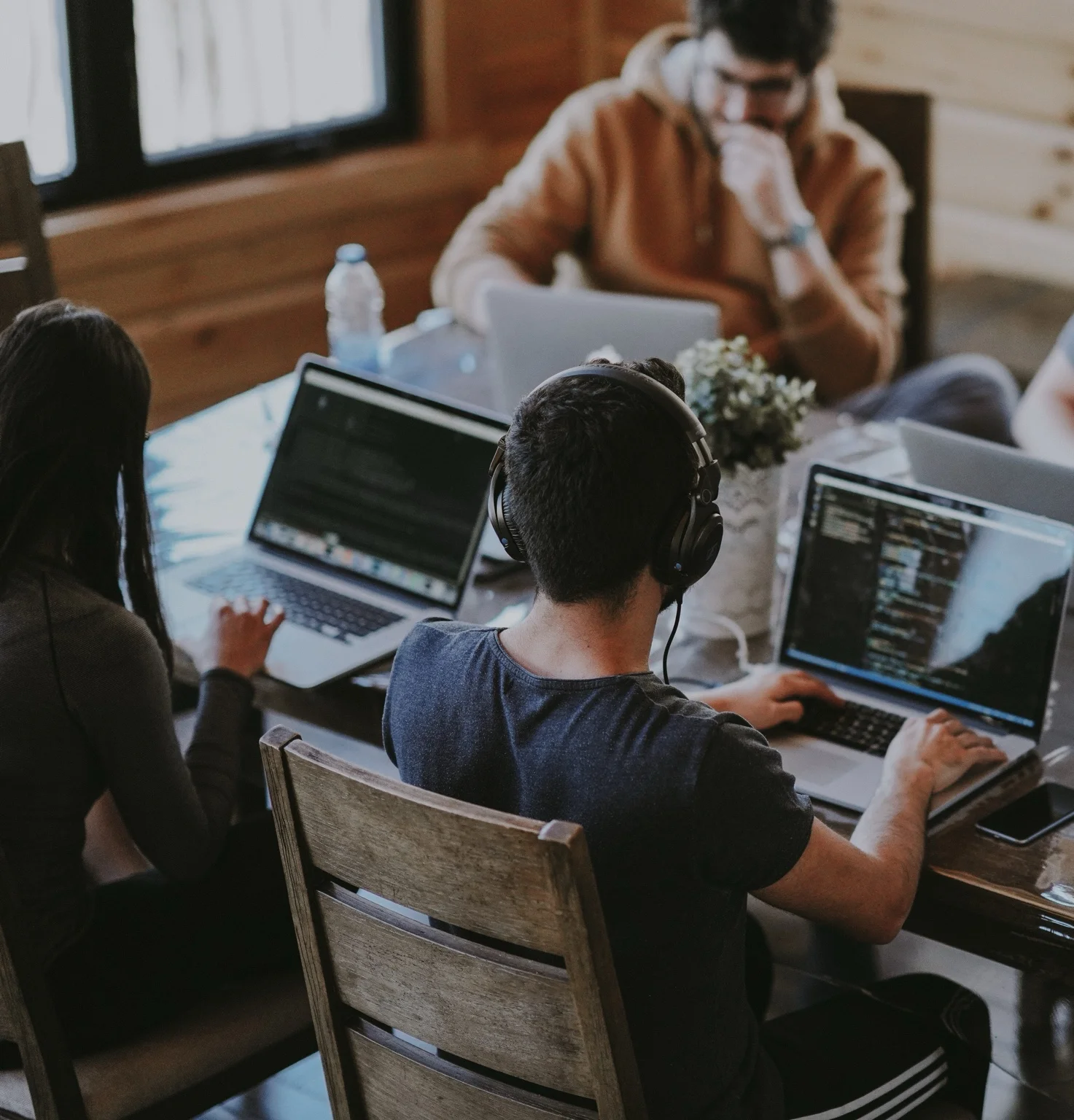 Freelance web developers collaborating on website development projects using laptops and modern development tools